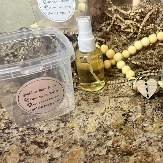 Goat Face Barn & Co. vehicle fragrance products on a granite surface