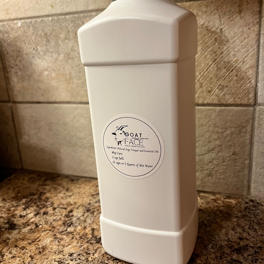 White bottle with a label on a tiled bathroom counter